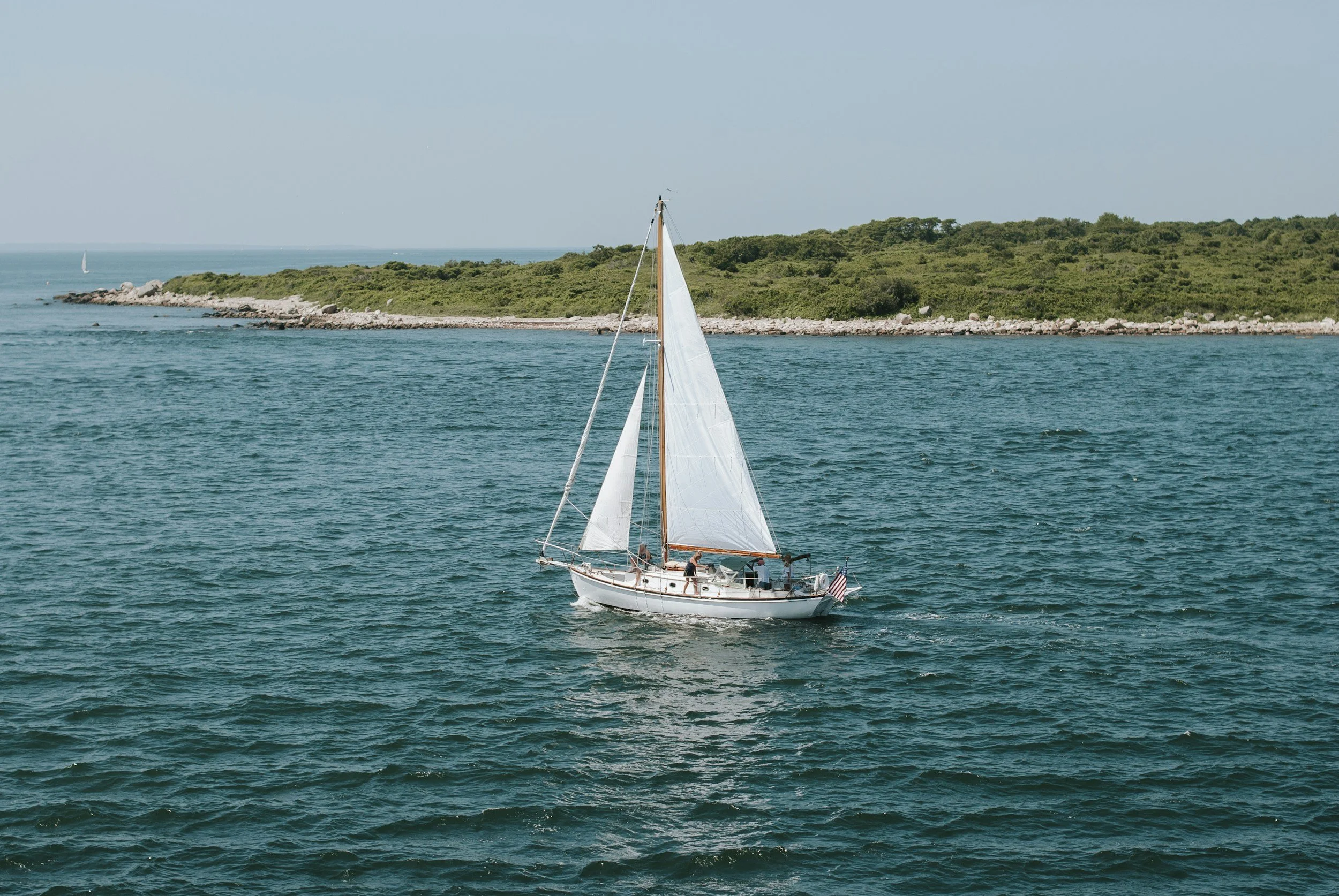 A sailboat off the Cape Ann coast near Rising Tide's service area
